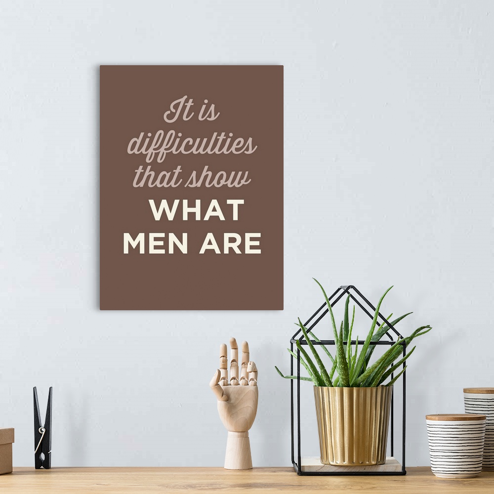 A bohemian room featuring "It Is difficulties That Show What Men Are" on a brown background.