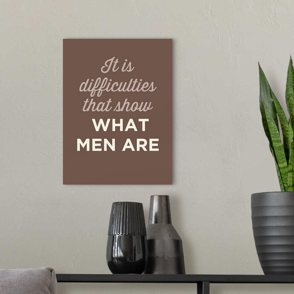 A modern room featuring "It Is difficulties That Show What Men Are" on a brown background.