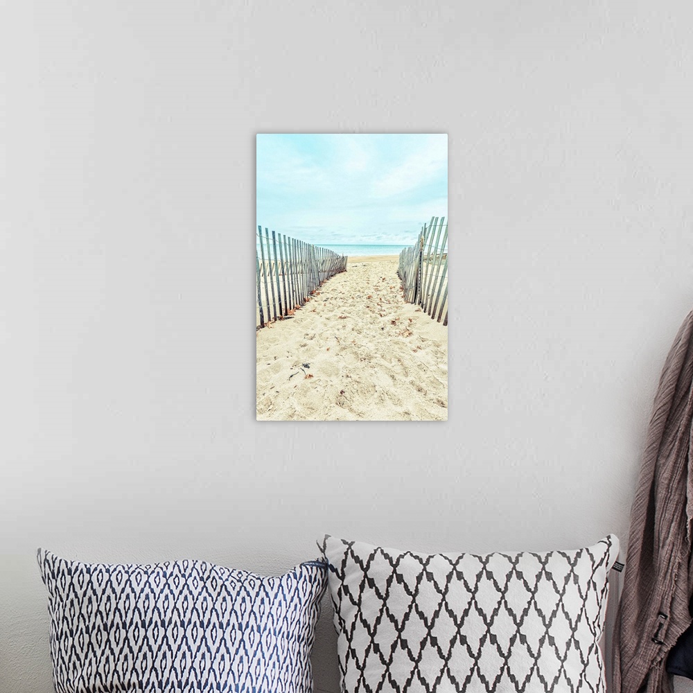 A bohemian room featuring A sandy path through the dunes to a sandy beach.