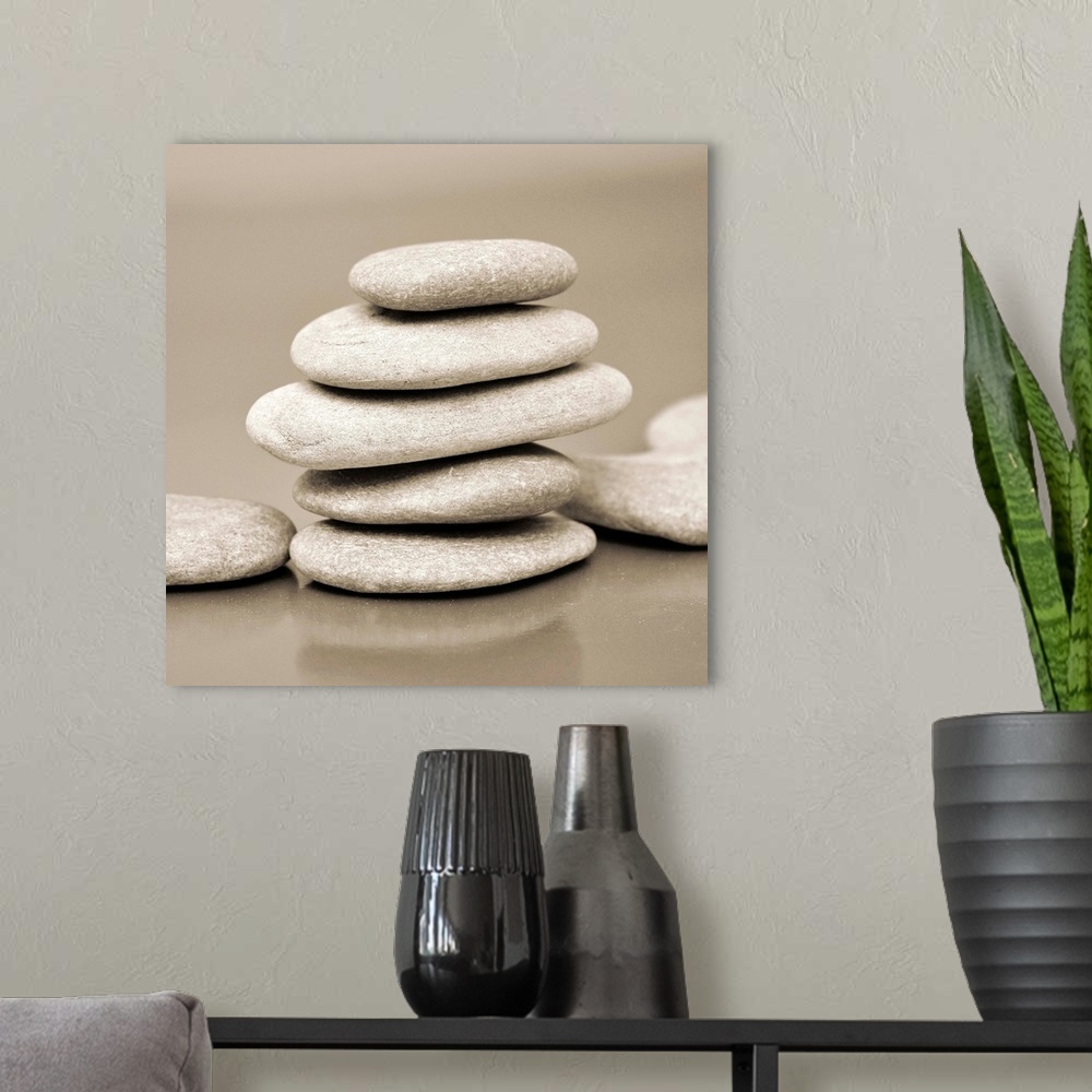 A modern room featuring Square monotone image of a stack on smooth rocks.