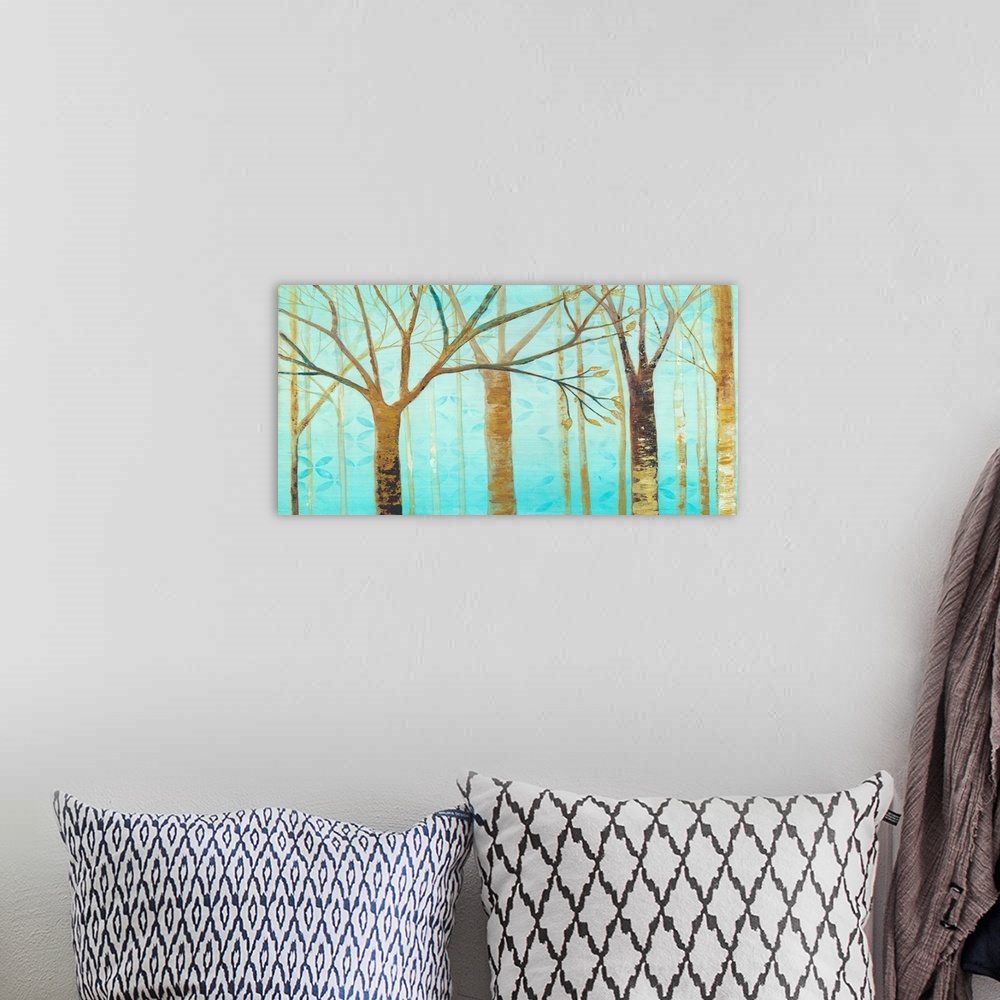 A bohemian room featuring Contemporary artwork of brown trees against a teal background sky.
