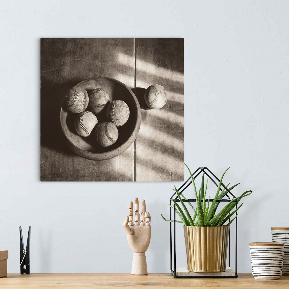 A bohemian room featuring Photograph in sepia tones of a bowl of baseballs by Judy B. Messer.