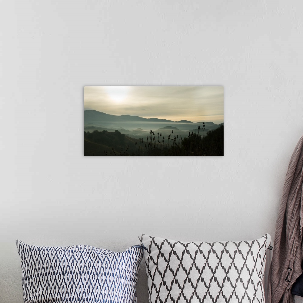 A bohemian room featuring Photograph of fog in the mountain with darks and lights reflecting on the clouds.