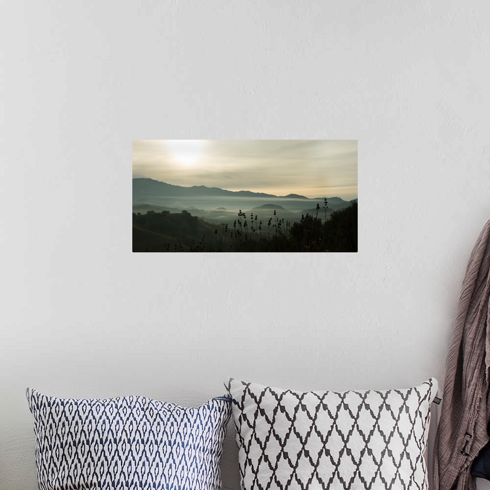 A bohemian room featuring Photograph of fog in the mountain with darks and lights reflecting on the clouds.