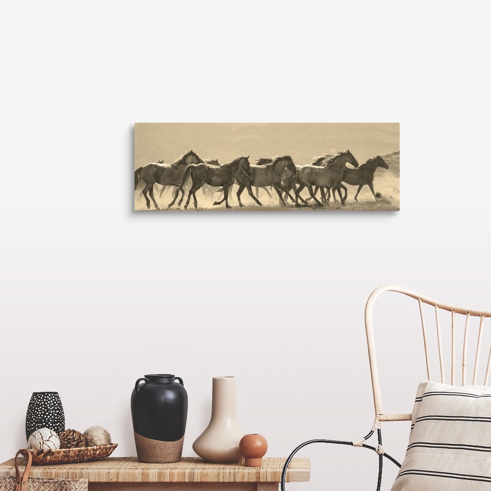 A farmhouse room featuring Photograph in sepia of a parade of horses in a dusty field.