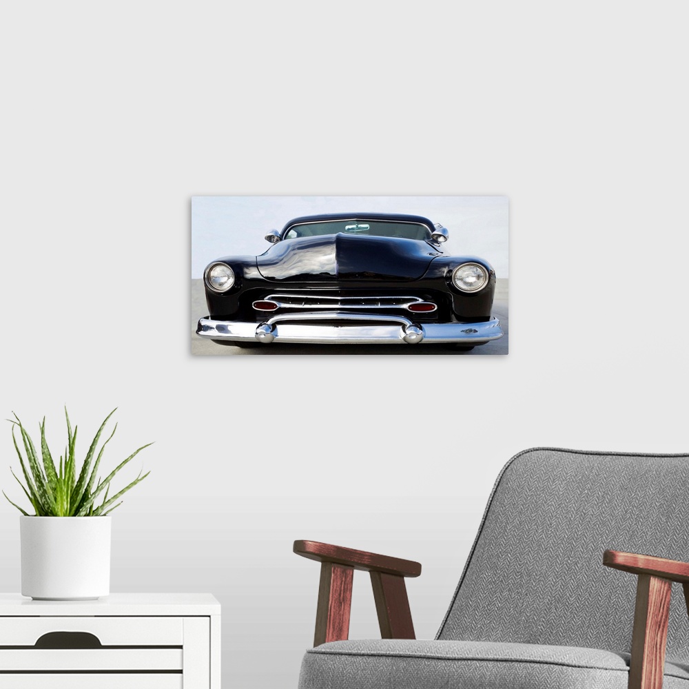A modern room featuring Photograph in black and white of the front end of a classic hot rod.