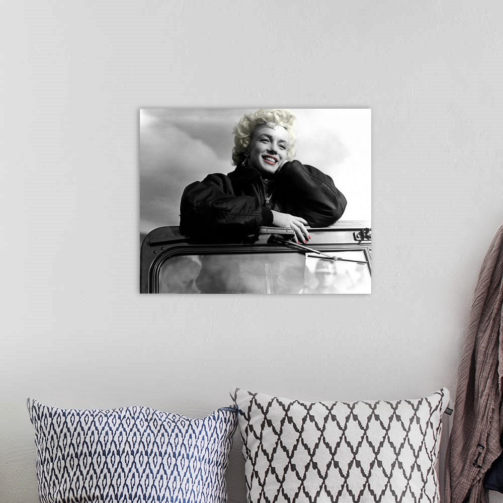 A bohemian room featuring Photograph with color tint highlights of Marilyn Monroe's favorite shot from entertaining the tro...