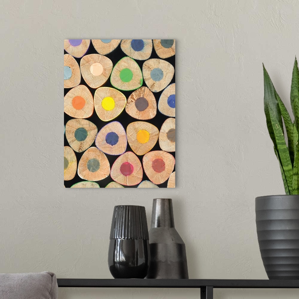 A modern room featuring Close up photograph of ends of stacked colored pencils.