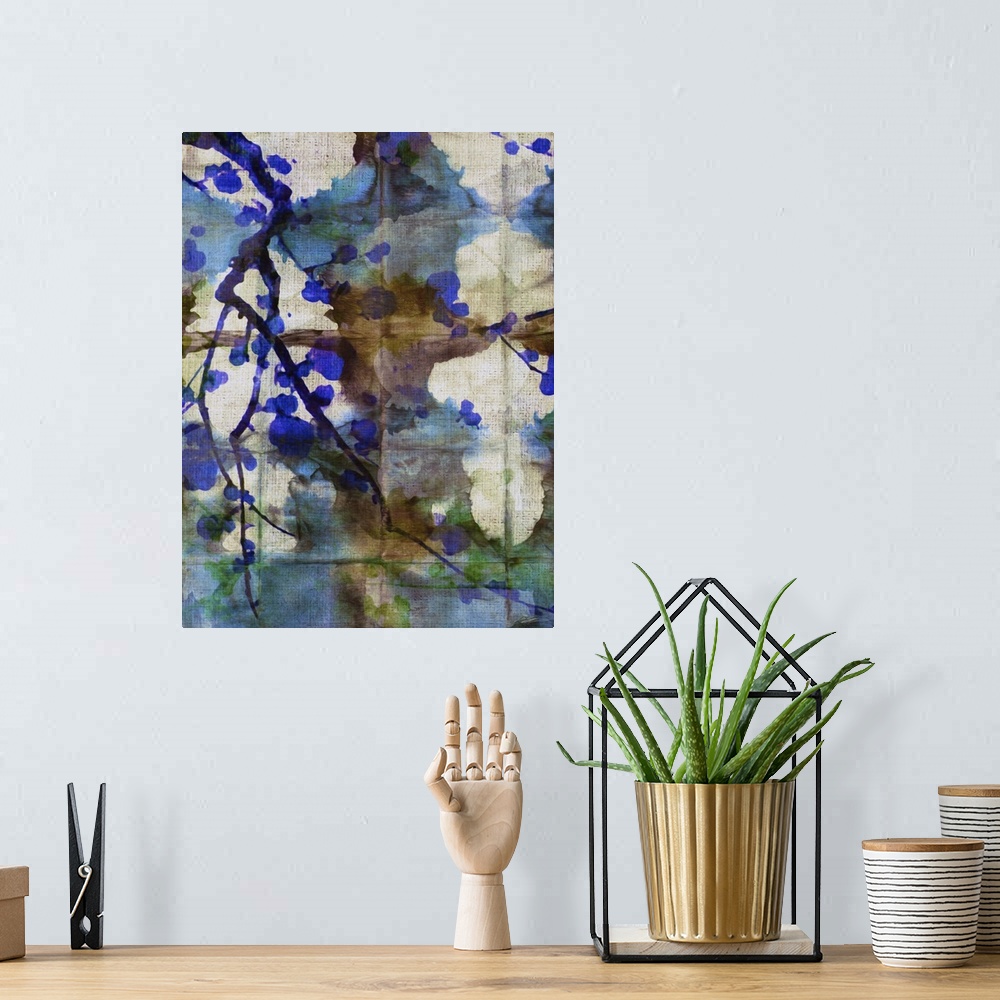 A bohemian room featuring A shibori painting with colorful folds and branches of cherry blossoms.