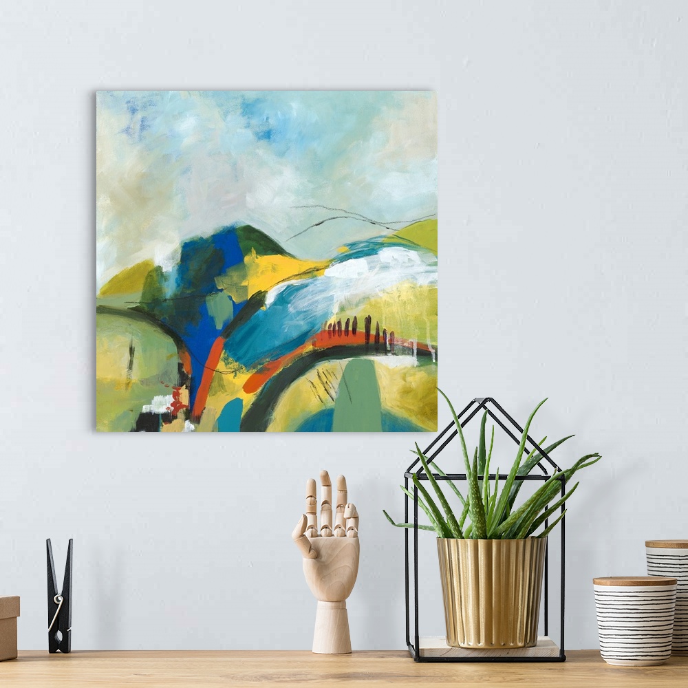 A bohemian room featuring Square abstract painting of a hilly landscape with vibrant colors and a few black lines on top.
