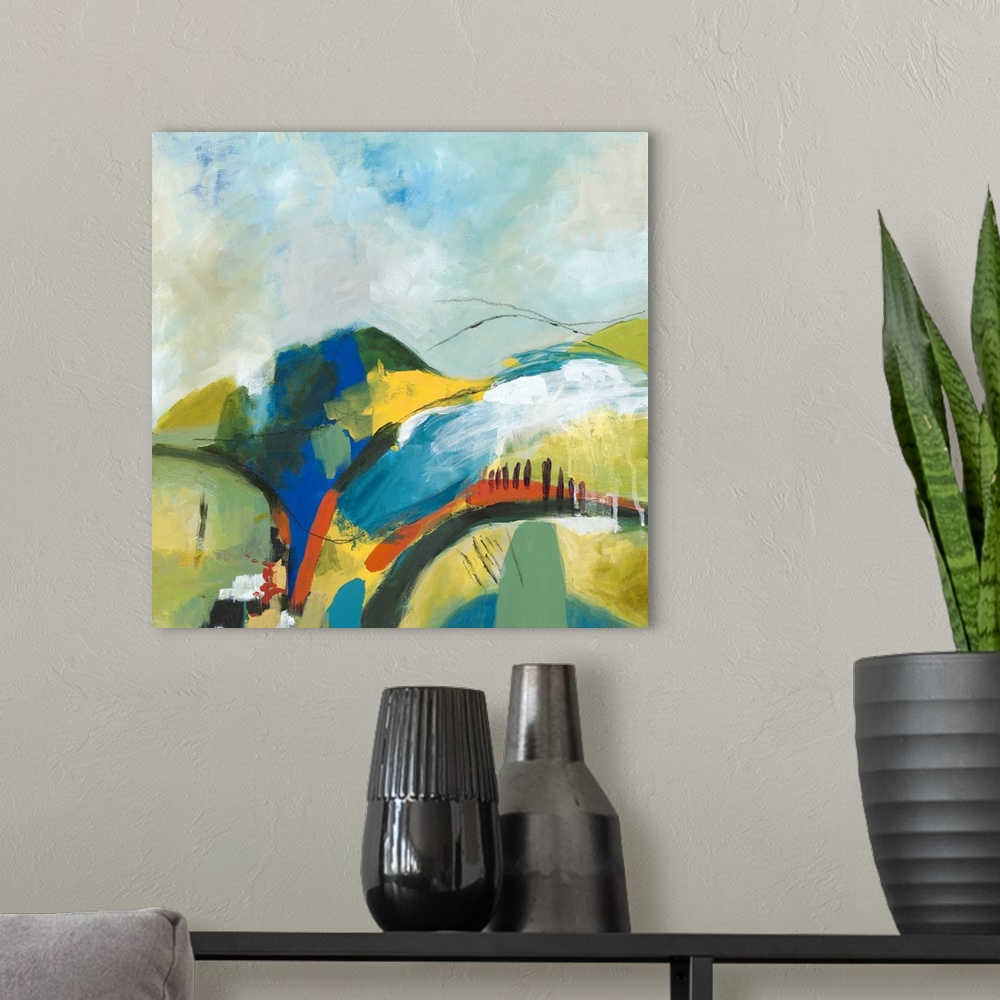 A modern room featuring Square abstract painting of a hilly landscape with vibrant colors and a few black lines on top.