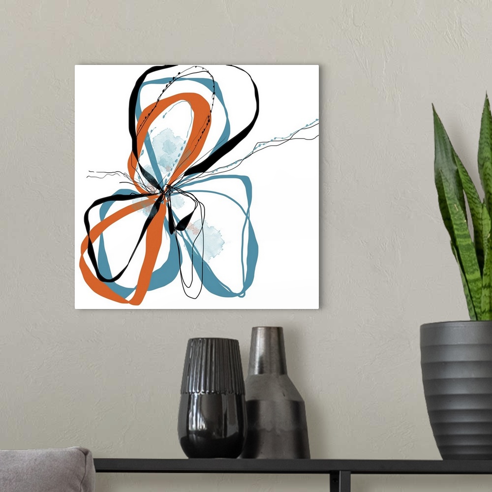 A modern room featuring a bright floral with flowing lines of intertwined colors like aqua, tangerine and black.