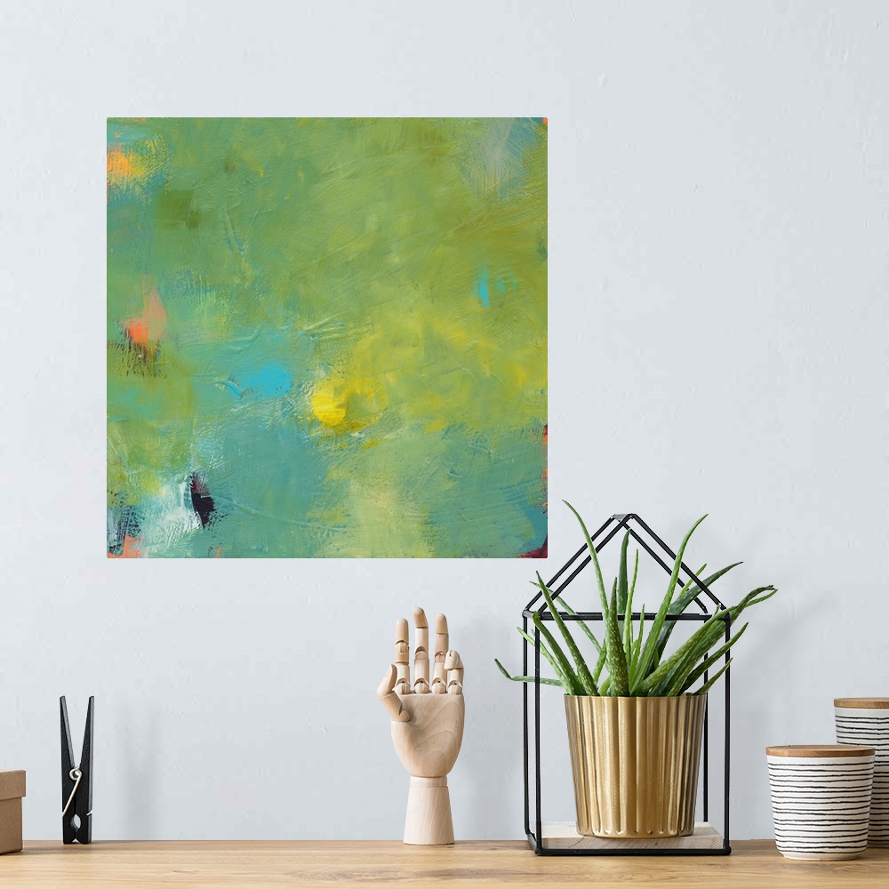 A bohemian room featuring A contemporary abstract painting with shades of green, yellow, and blue on top and hints of orang...