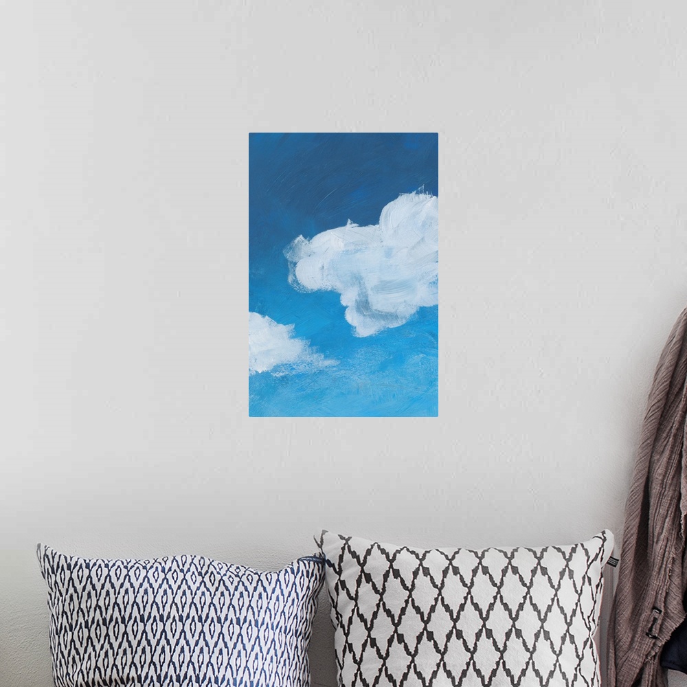 A bohemian room featuring Contemporary artwork of fluffy white clouds against a gradated blue background.