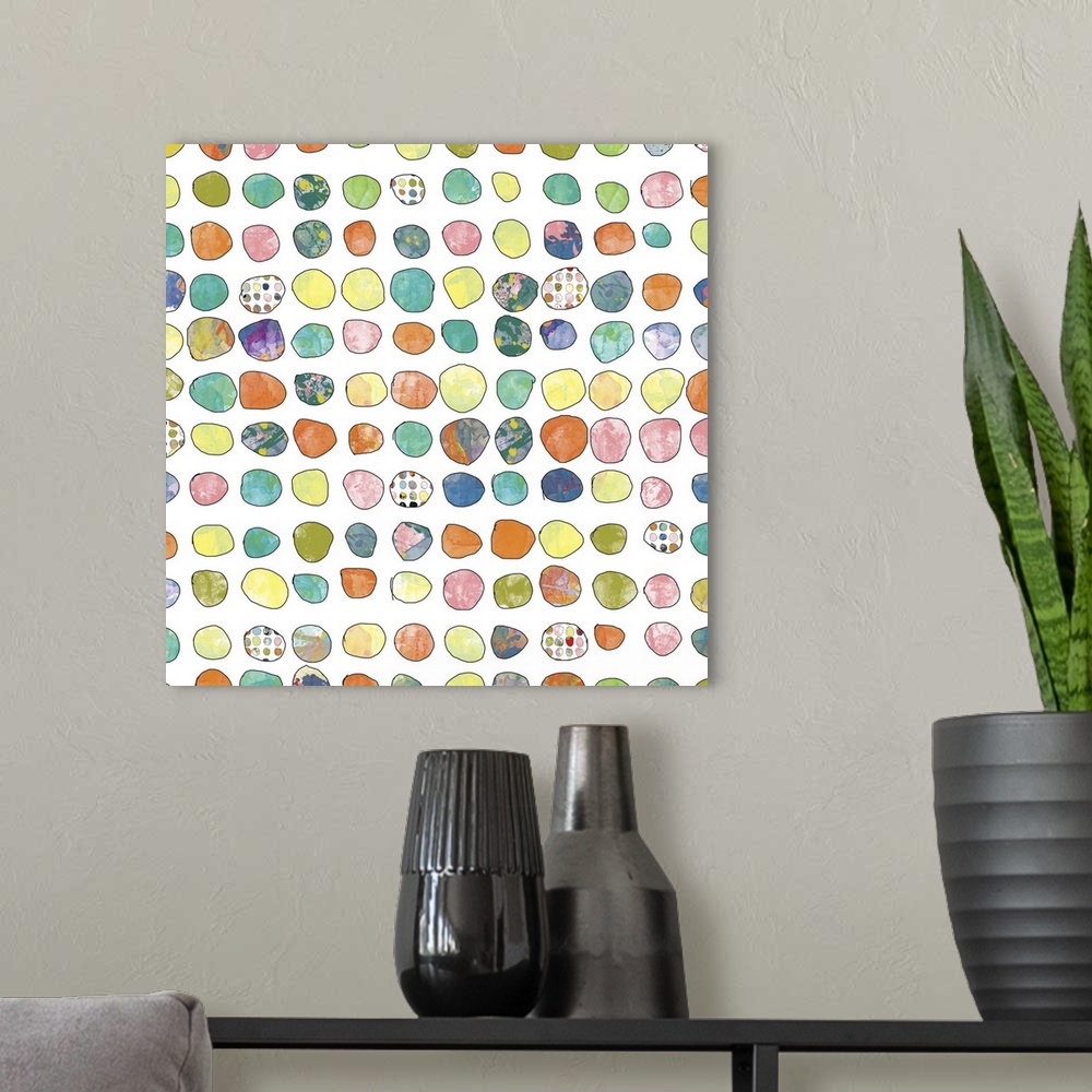 A modern room featuring Contemporary artwork of over a hundred dots that are different colors and designs.