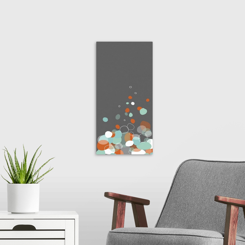 A modern room featuring Large, vertical contemporary art of various circular shapes on a solid background.  The shapes re...