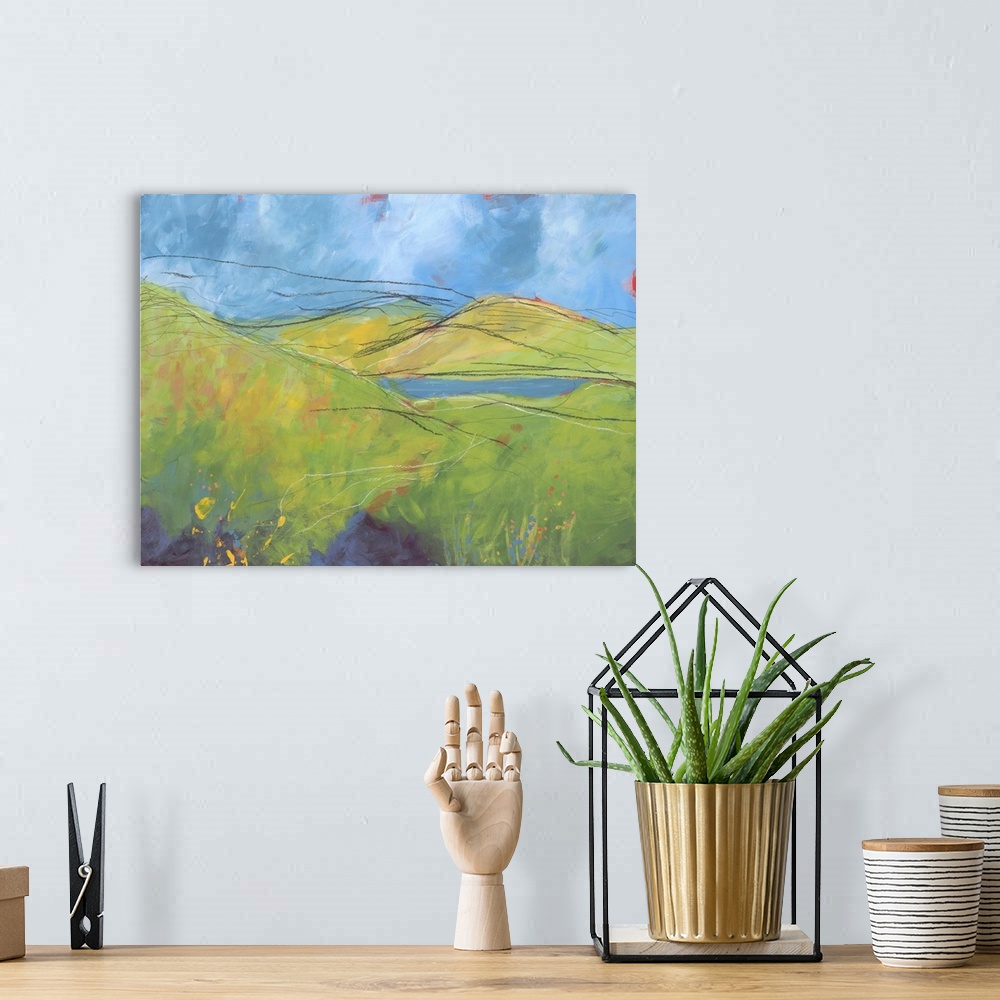 A bohemian room featuring Contemporary painting of a landscape with rolling green hills and pastel colored paint splatter r...