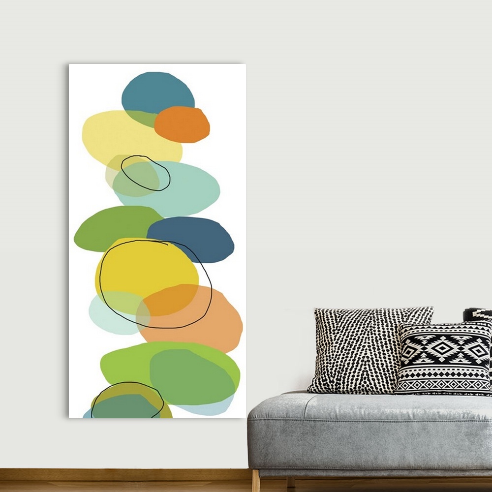 A bohemian room featuring Vertical, oversized contemporary artwork of multi-colored circular shapes resembling rocks that h...