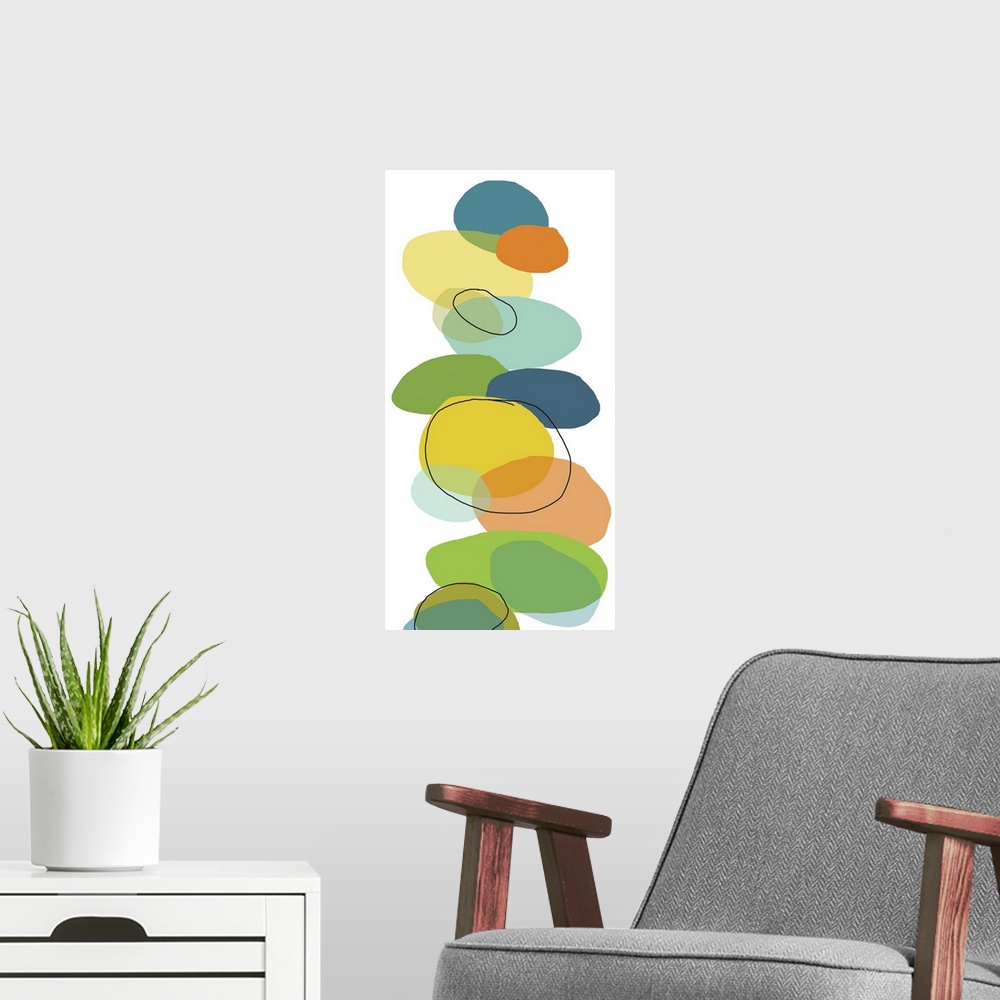A modern room featuring Vertical, oversized contemporary artwork of multi-colored circular shapes resembling rocks that h...