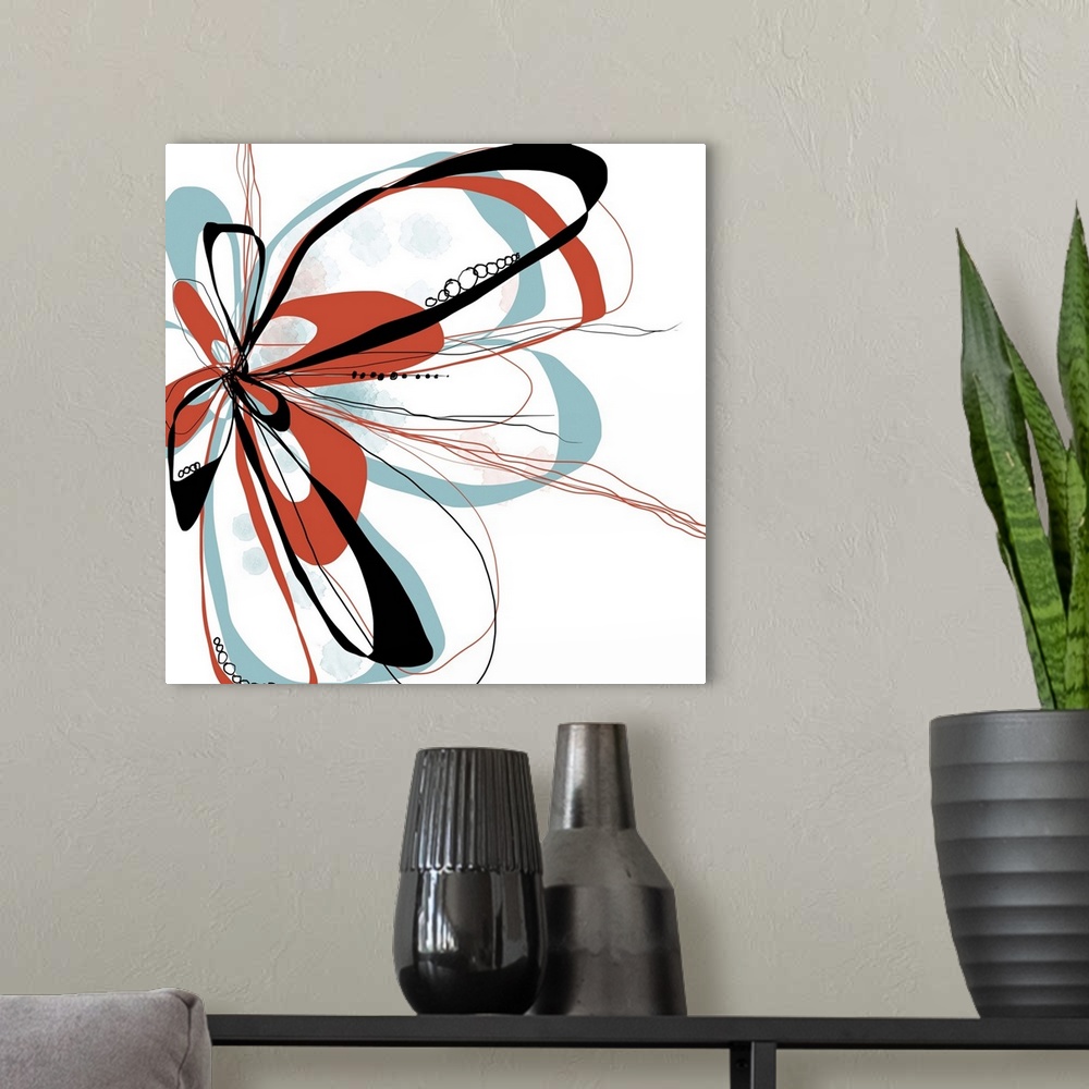 A modern room featuring a bright floral with flowing lines of intertwined colors like aqua, tangerine and black.