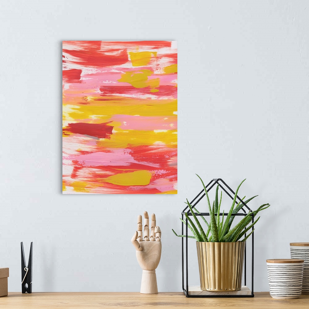 A bohemian room featuring Vertical abstract painting of sweeping horizontal brush strokes in yellow, pink and red.