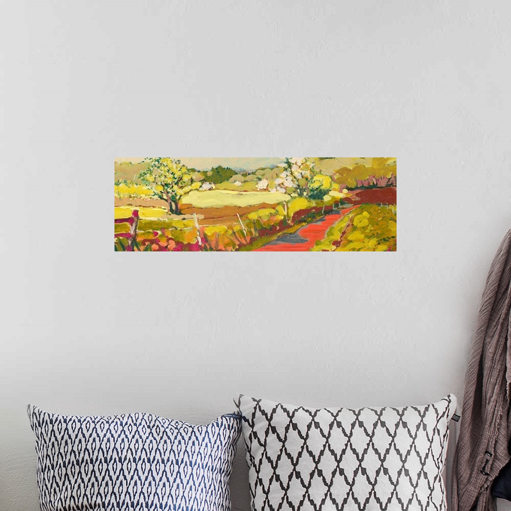 A bohemian room featuring A panoramic piece of artwork that displays a road in the countryside.  The fence and large tree i...