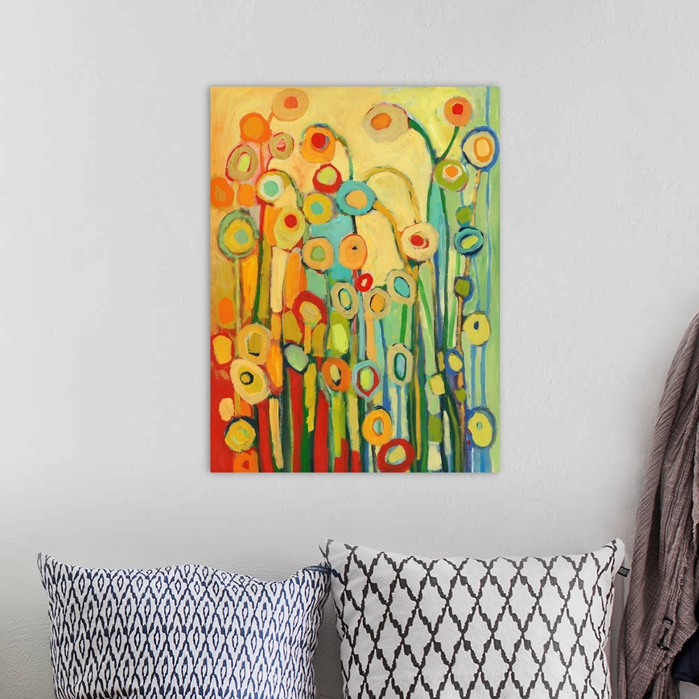 A bohemian room featuring Vertical, abstract painting of simplified flower shapes in a kaleidoscope of colors.