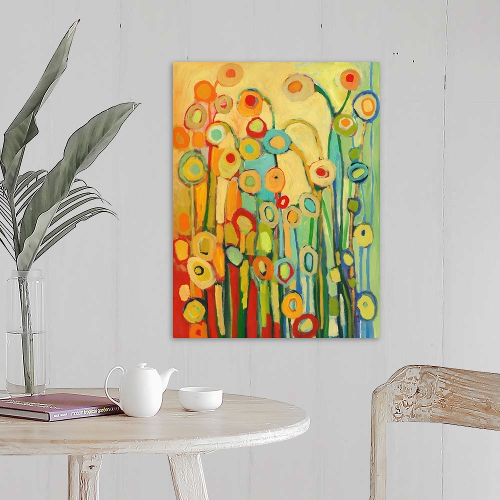 A farmhouse room featuring Vertical, abstract painting of simplified flower shapes in a kaleidoscope of colors.
