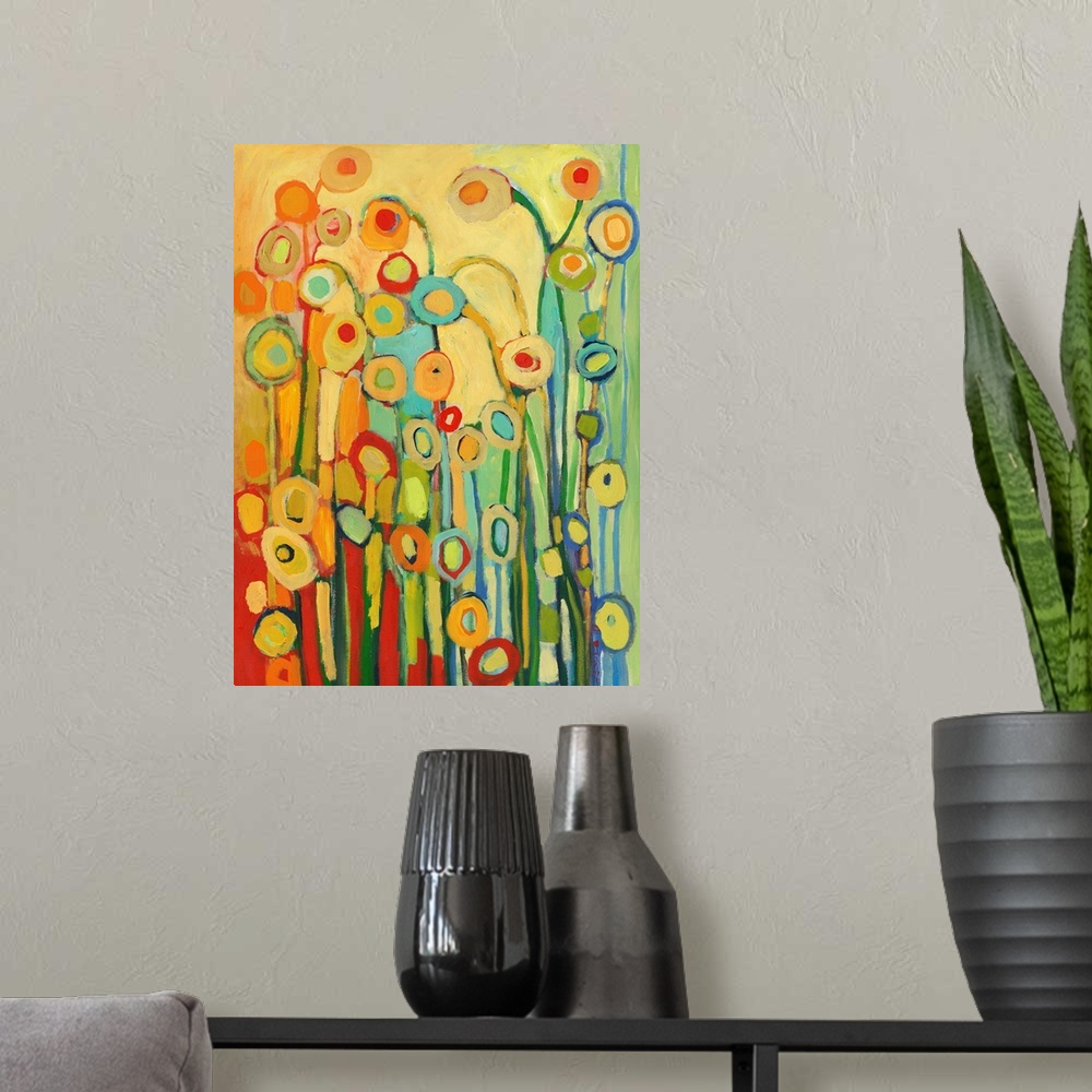 A modern room featuring Vertical, abstract painting of simplified flower shapes in a kaleidoscope of colors.