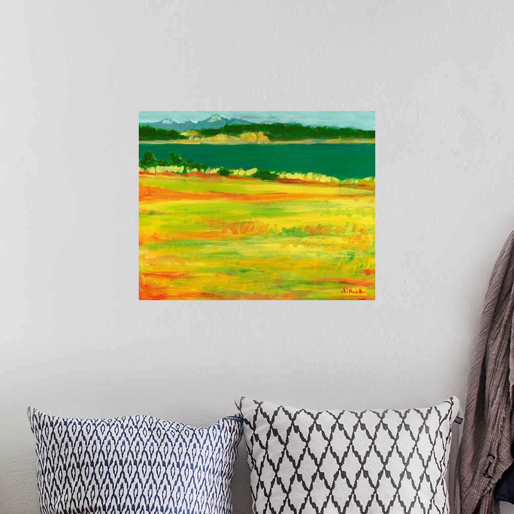 A bohemian room featuring A contemporary painting with a view to the mountains across a grassy field and body of water.