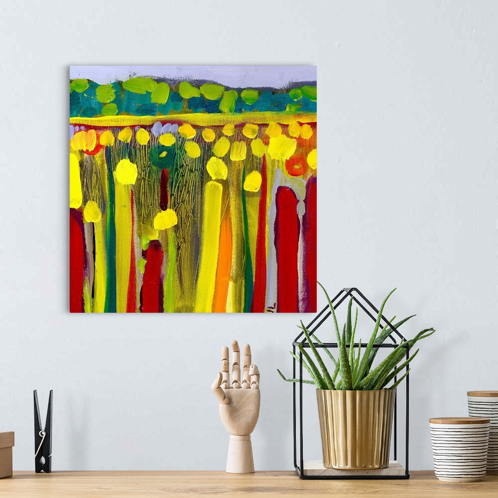 A bohemian room featuring Large contemporary art depicts an open field of flowers in the foreground contrasted by rolling h...