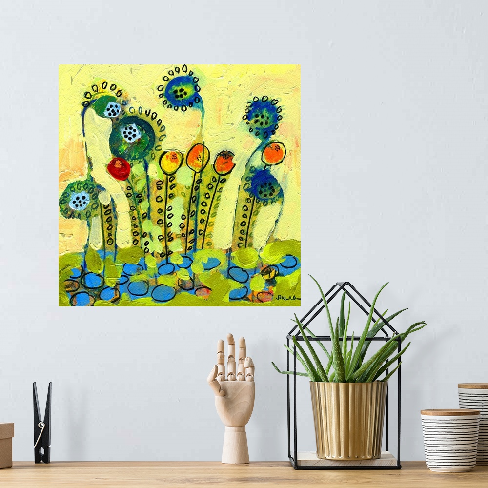 A bohemian room featuring Brightly painted abstract wall art of flowers with heavy paint texture on top of them.