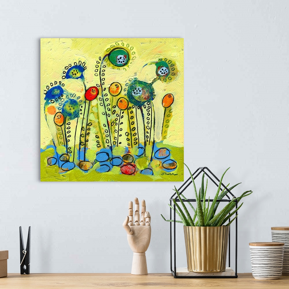 A bohemian room featuring Contemporary abstract painting of seeds blossoming into flowers.  Simple shapes are used to creat...
