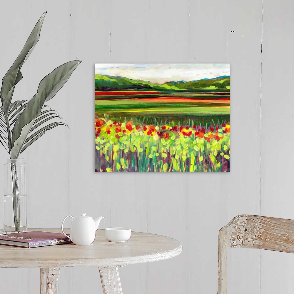 A farmhouse room featuring Large, landscape fine art painting of a meadow of wildflowers in front of a green hillside on the...