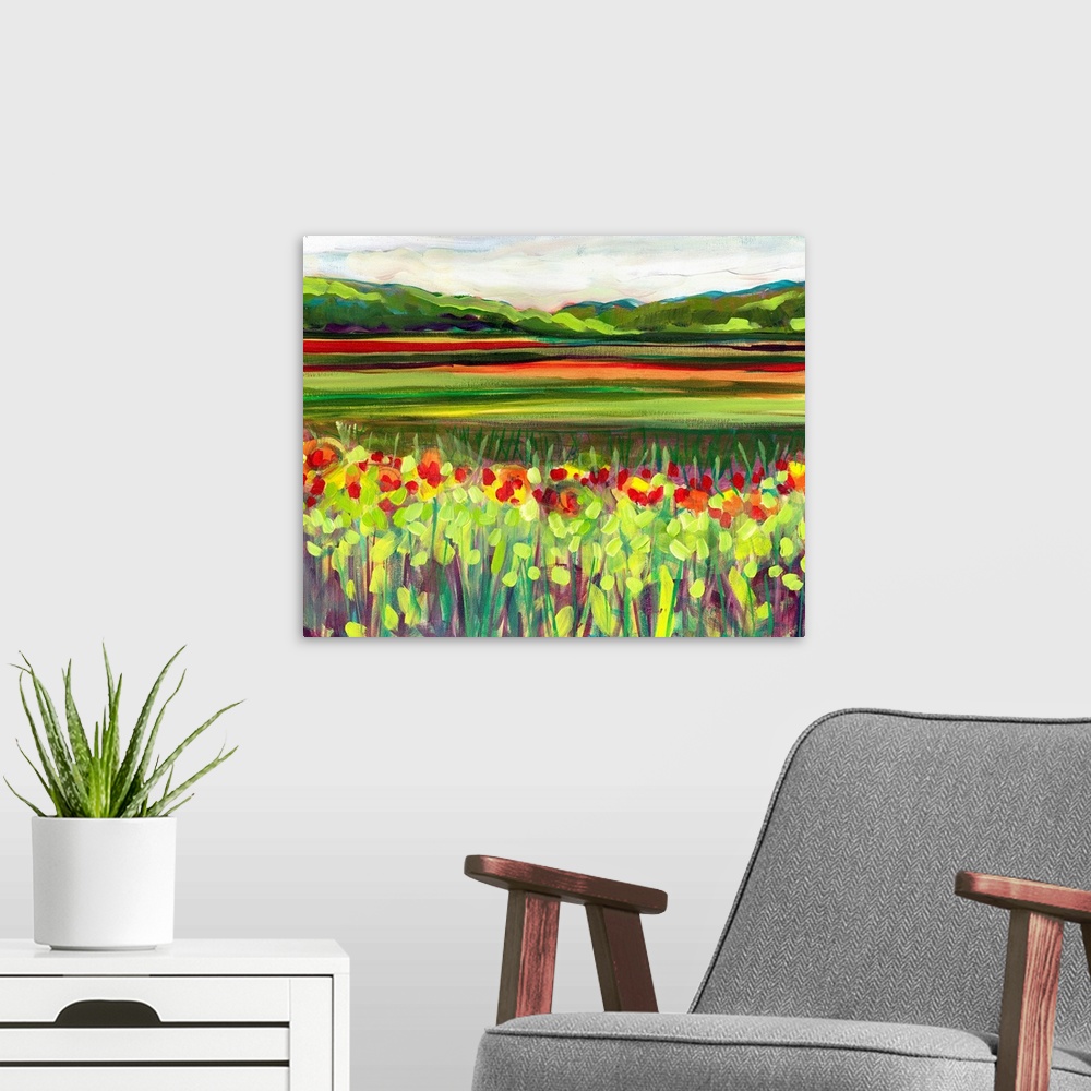 A modern room featuring Large, landscape fine art painting of a meadow of wildflowers in front of a green hillside on the...