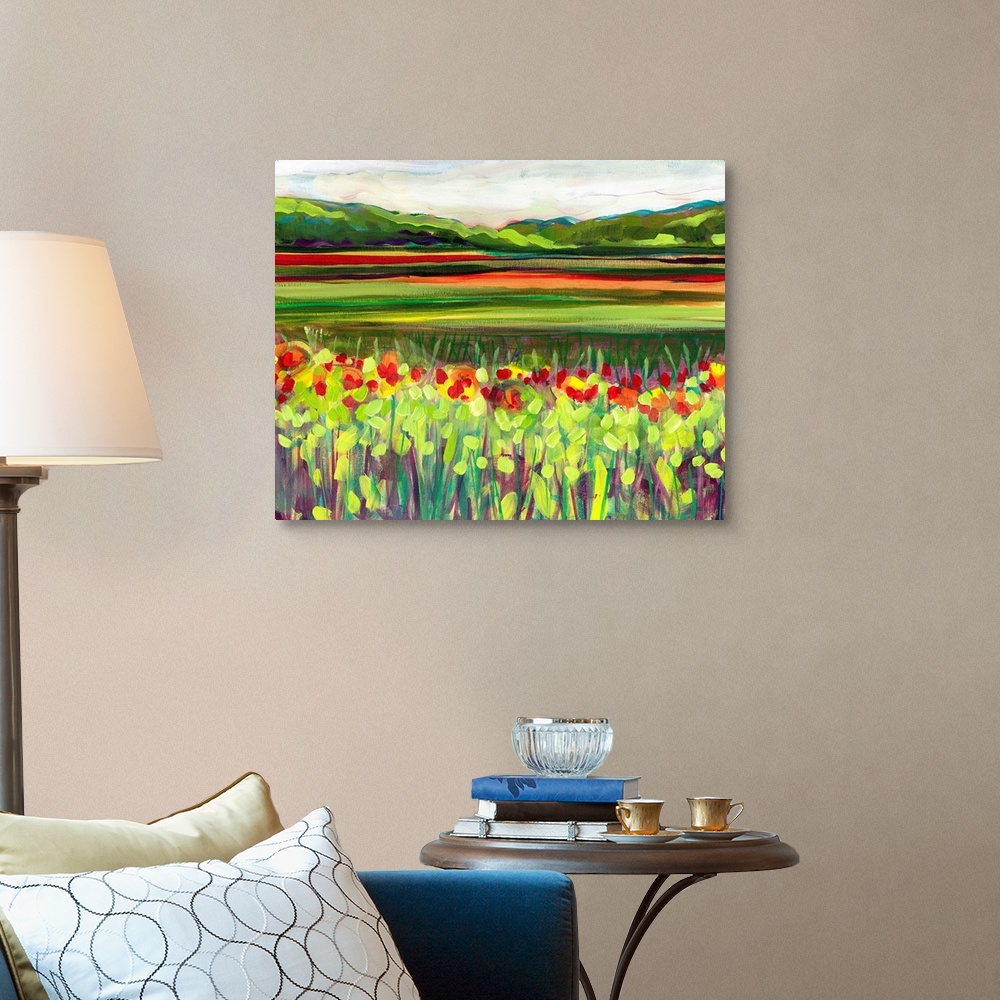 A traditional room featuring Large, landscape fine art painting of a meadow of wildflowers in front of a green hillside on the...