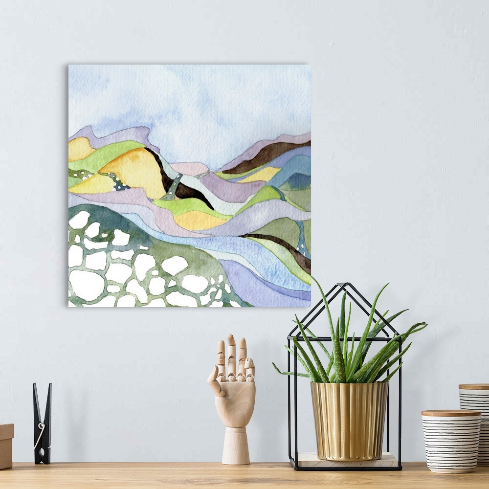 A bohemian room featuring Contemporary watercolor painting of a landscape with a river running through pastel-colored hills.