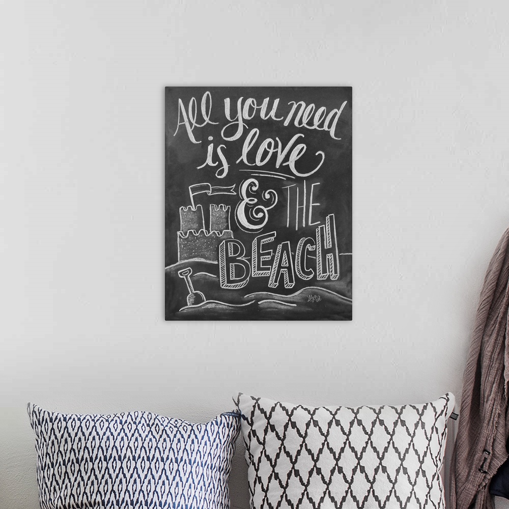 A bohemian room featuring "All you need is love and the beach" handwritten with a drawing of a sand castle.