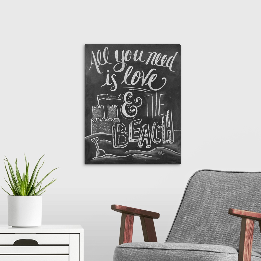 A modern room featuring "All you need is love and the beach" handwritten with a drawing of a sand castle.