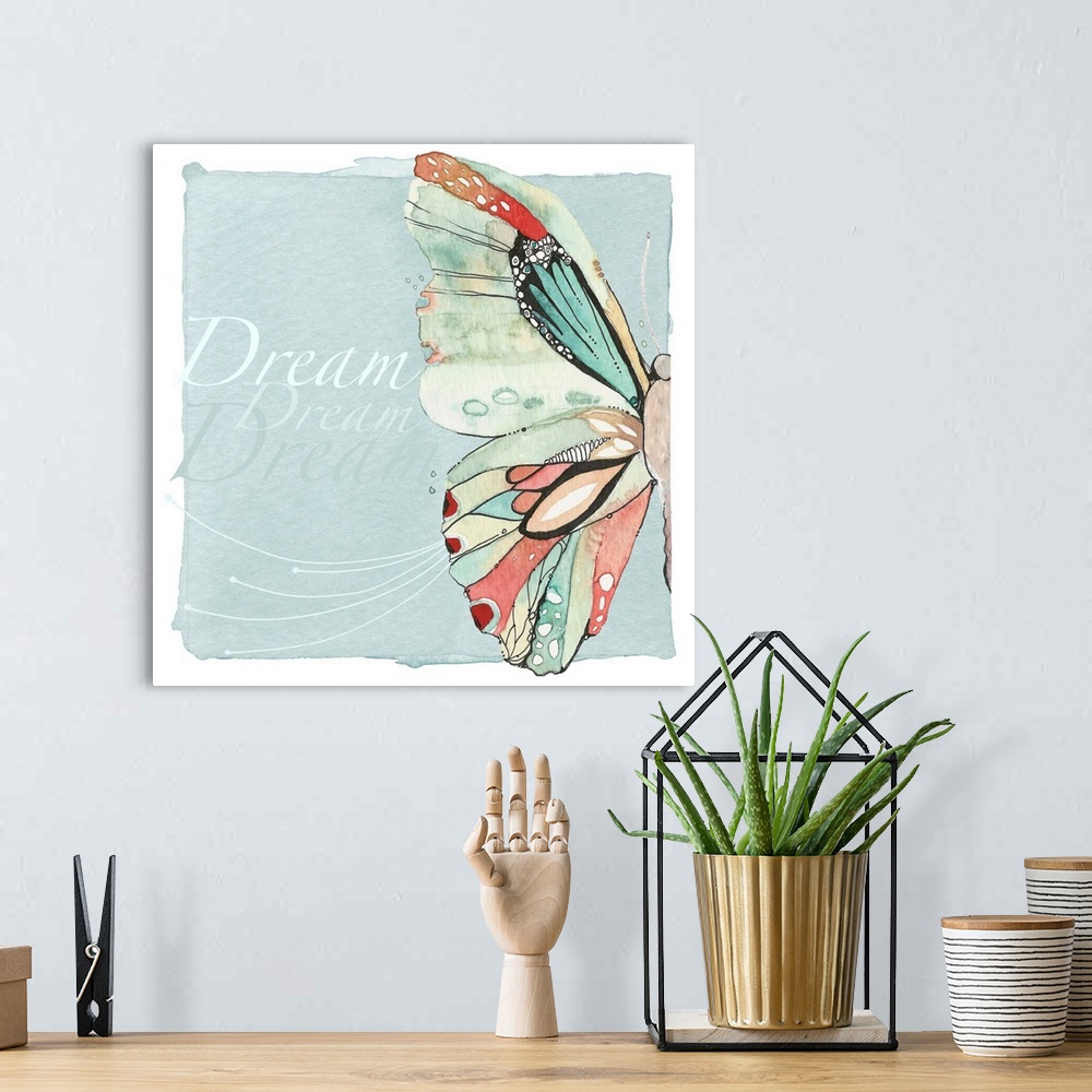 A bohemian room featuring Decorative watercolor painting of a colorful butterfly with the word "Dream" repeated in the back...