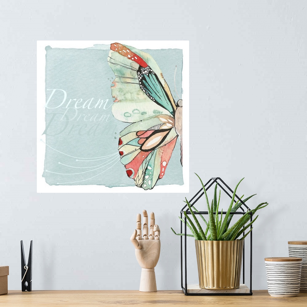 A bohemian room featuring Decorative watercolor painting of a colorful butterfly with the word "Dream" repeated in the back...