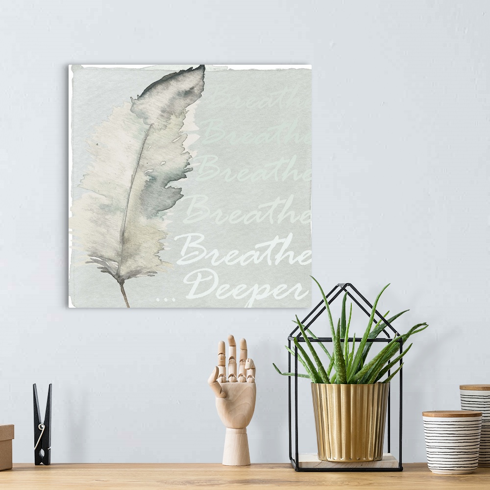 A bohemian room featuring Decorative watercolor painting of a feather in grey tones with the words "Breathe Deeper."
