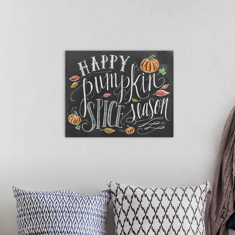 A bohemian room featuring "Happy pumpkin spice season" handwritten and illustrated with leaves and pumpkins.