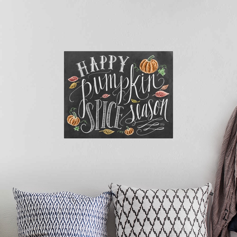A bohemian room featuring "Happy pumpkin spice season" handwritten and illustrated with leaves and pumpkins.
