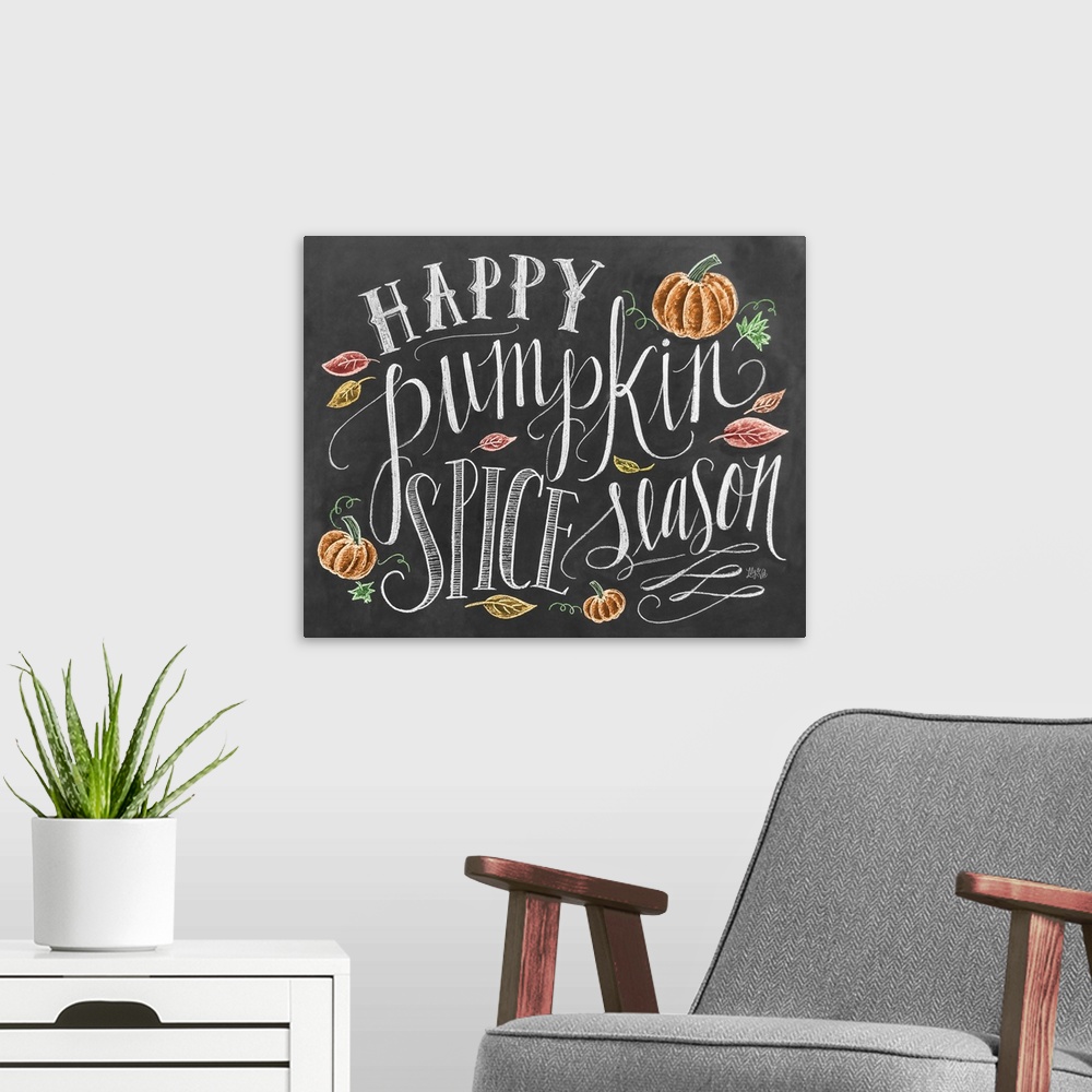 A modern room featuring "Happy pumpkin spice season" handwritten and illustrated with leaves and pumpkins.