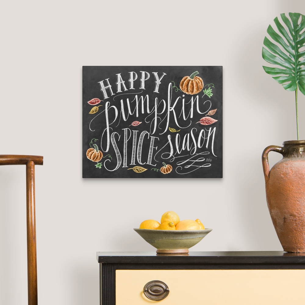A traditional room featuring "Happy pumpkin spice season" handwritten and illustrated with leaves and pumpkins.