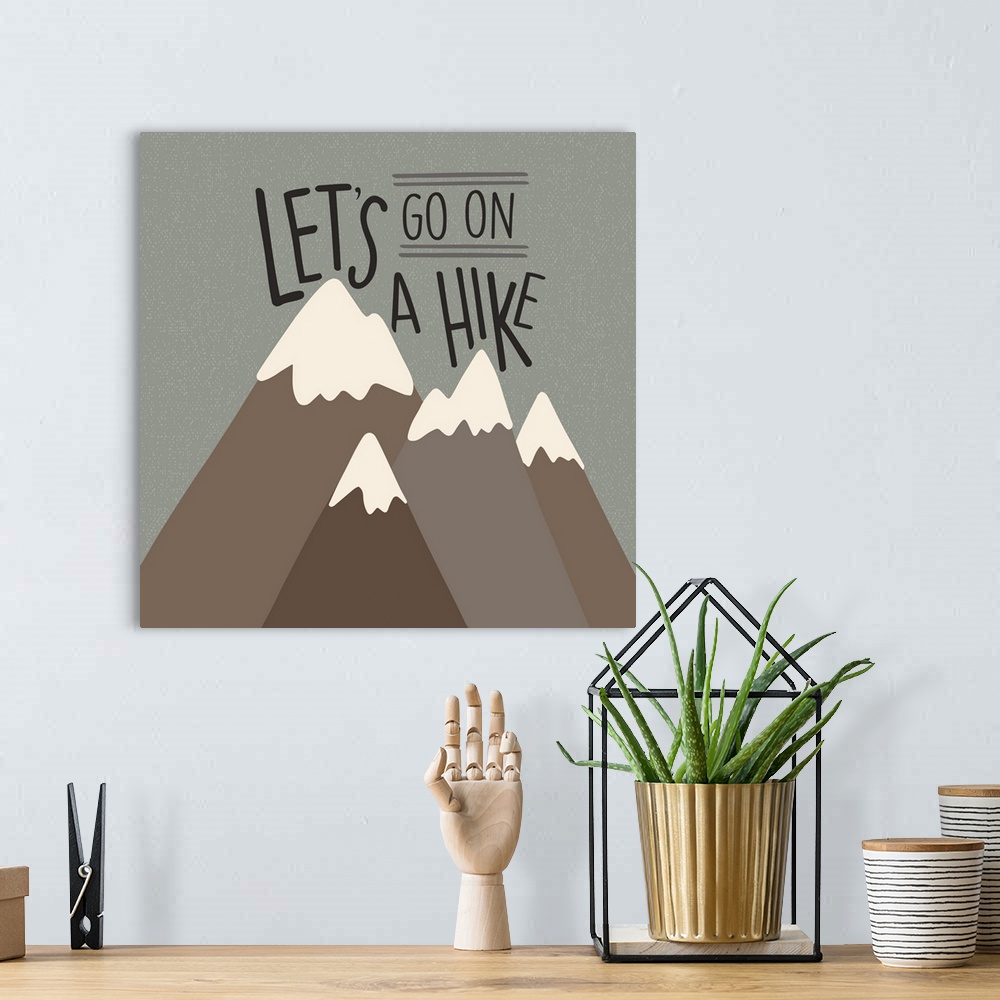 A bohemian room featuring "Let's go on a hike" written above a simple drawing of mountains.