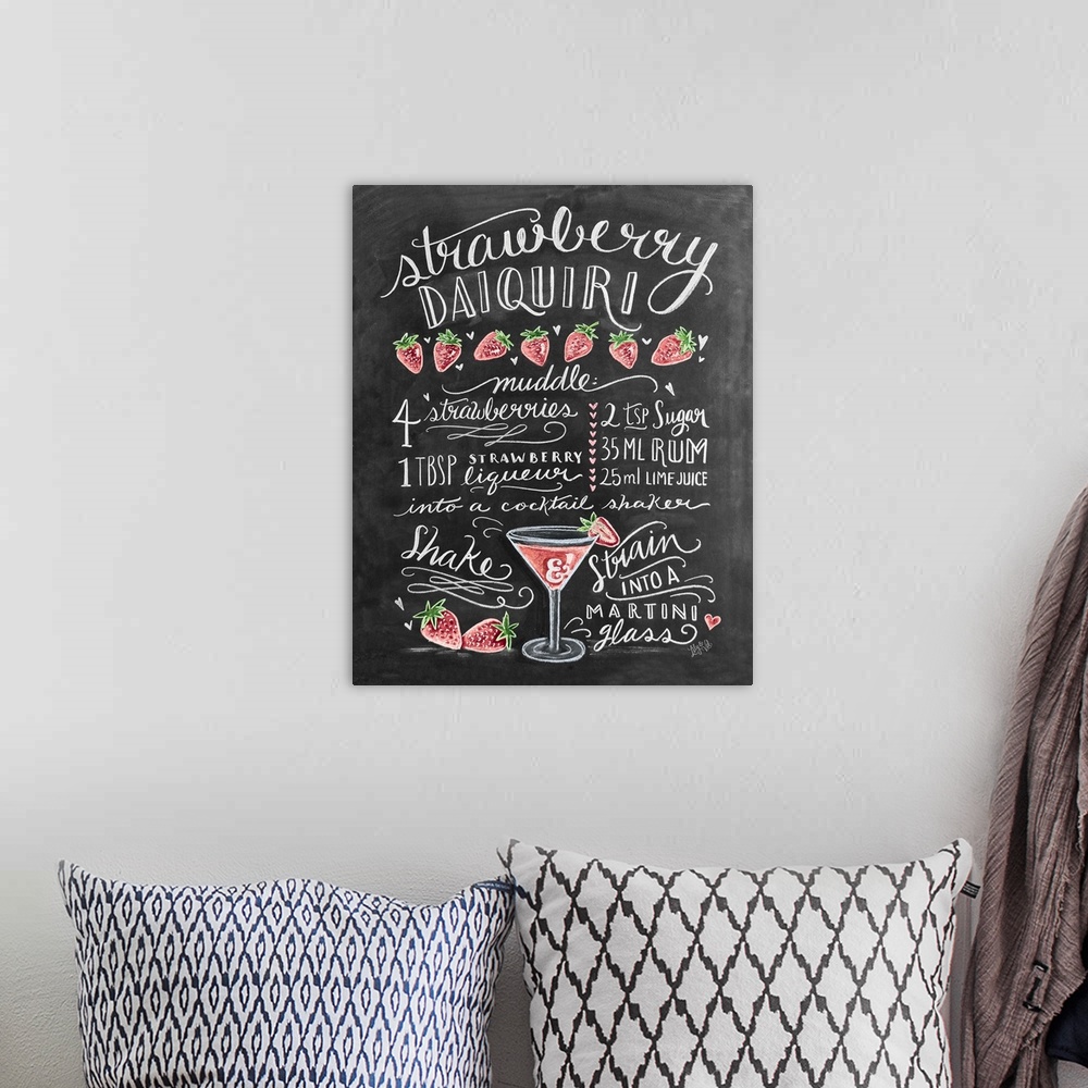 A bohemian room featuring Handlettered recipe for a Strawberry Daquiri cocktail with the appearance of a chalkboard drawing.