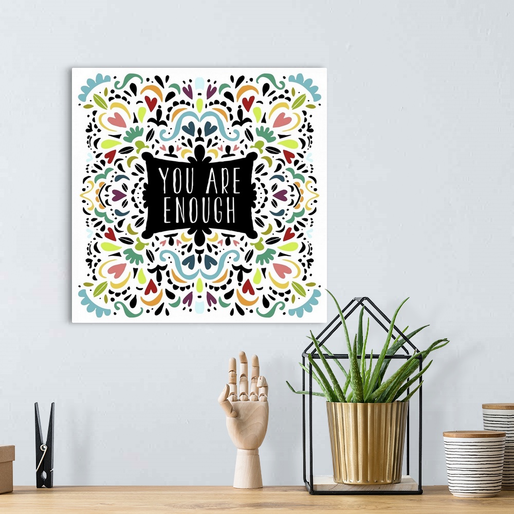A bohemian room featuring "You are enough" decorated with colorful shapes in a pattern.