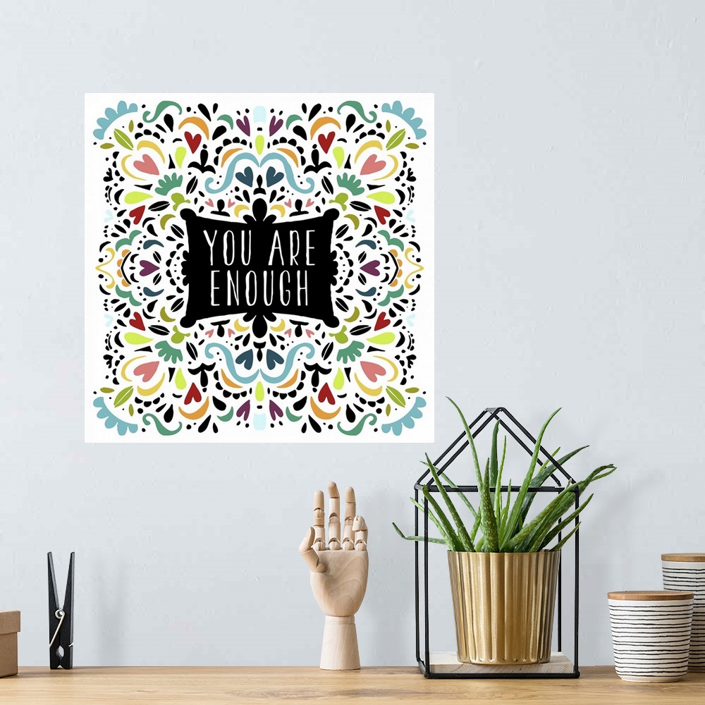 A bohemian room featuring "You are enough" decorated with colorful shapes in a pattern.